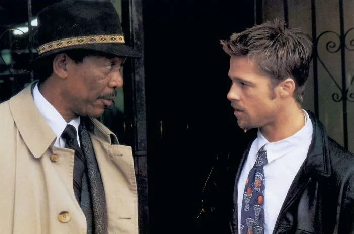 Brad Pitt and Morgan Freeman at a rain-soaked crime scene in the movie Seven.
