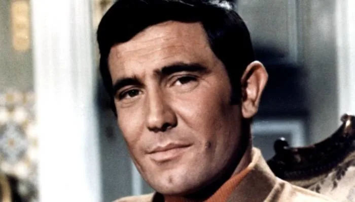George Lazenby posing in character during On Her Majesty's Secret Service