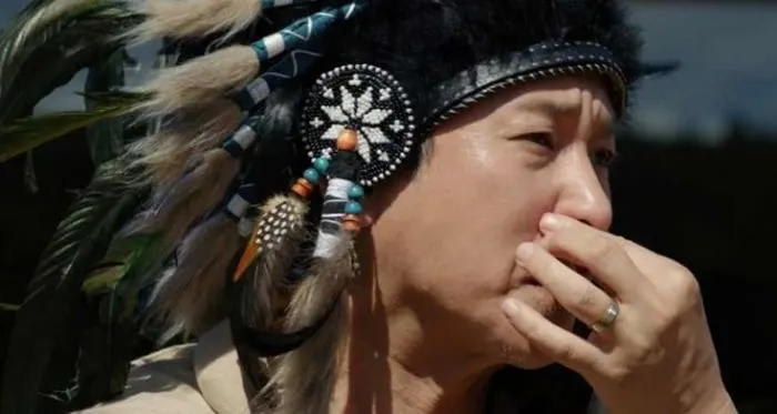 Mr. Park pinching his nose at the smell during the birthday party scene in Parasite
